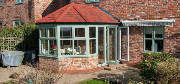 Green brick and glass conservatory built with planning permission in Nottingham.